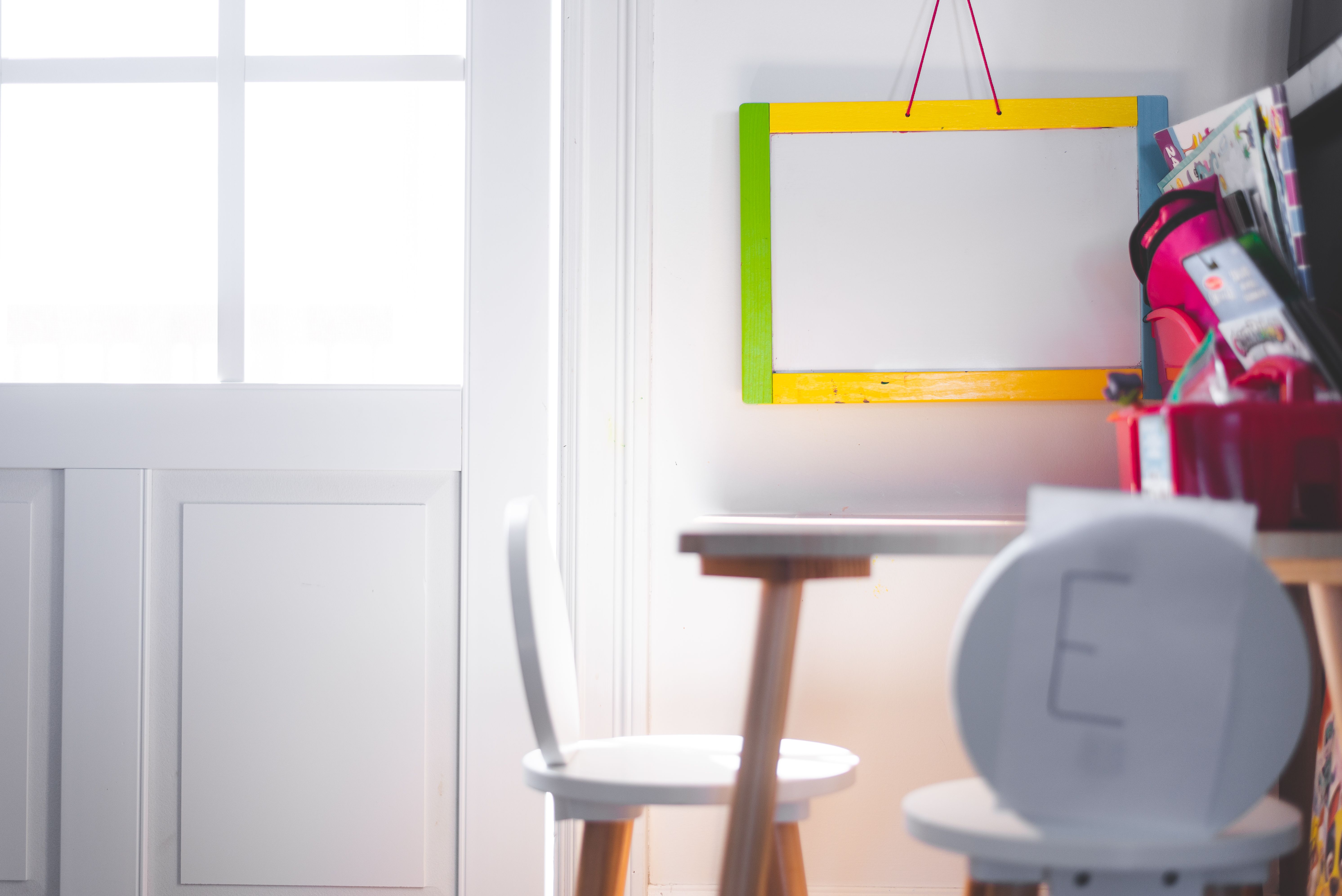 A quiet study corner with a small table, chairs and a whiteboard